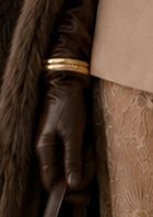 Gold bangles over gloves